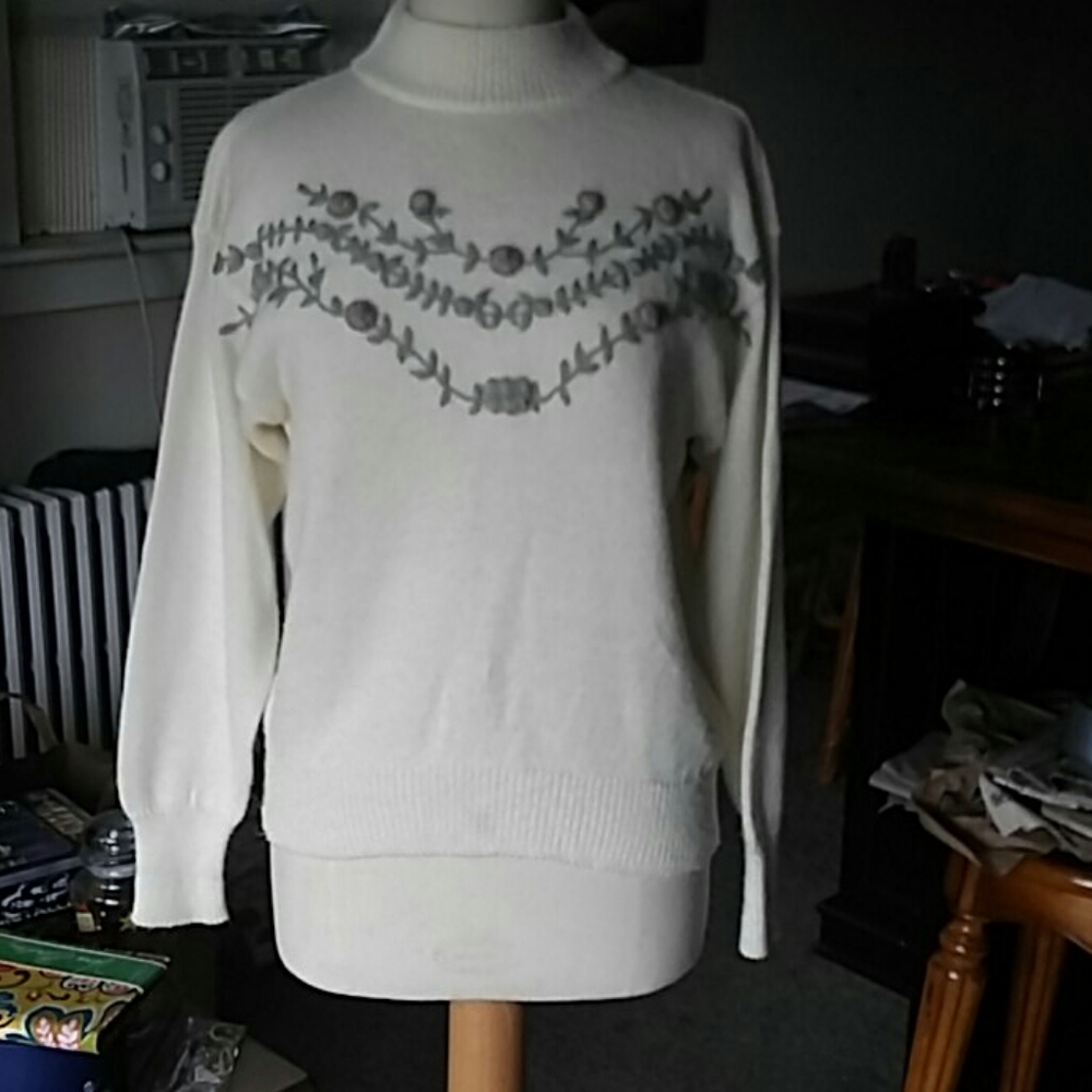 White sweater with purple rosettes